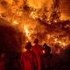 Firefighters monitor a backfire while battling the Ranch Fire, part of the Mendocino Complex Fire, near Ladoga, Calif., on August 7, 2018.